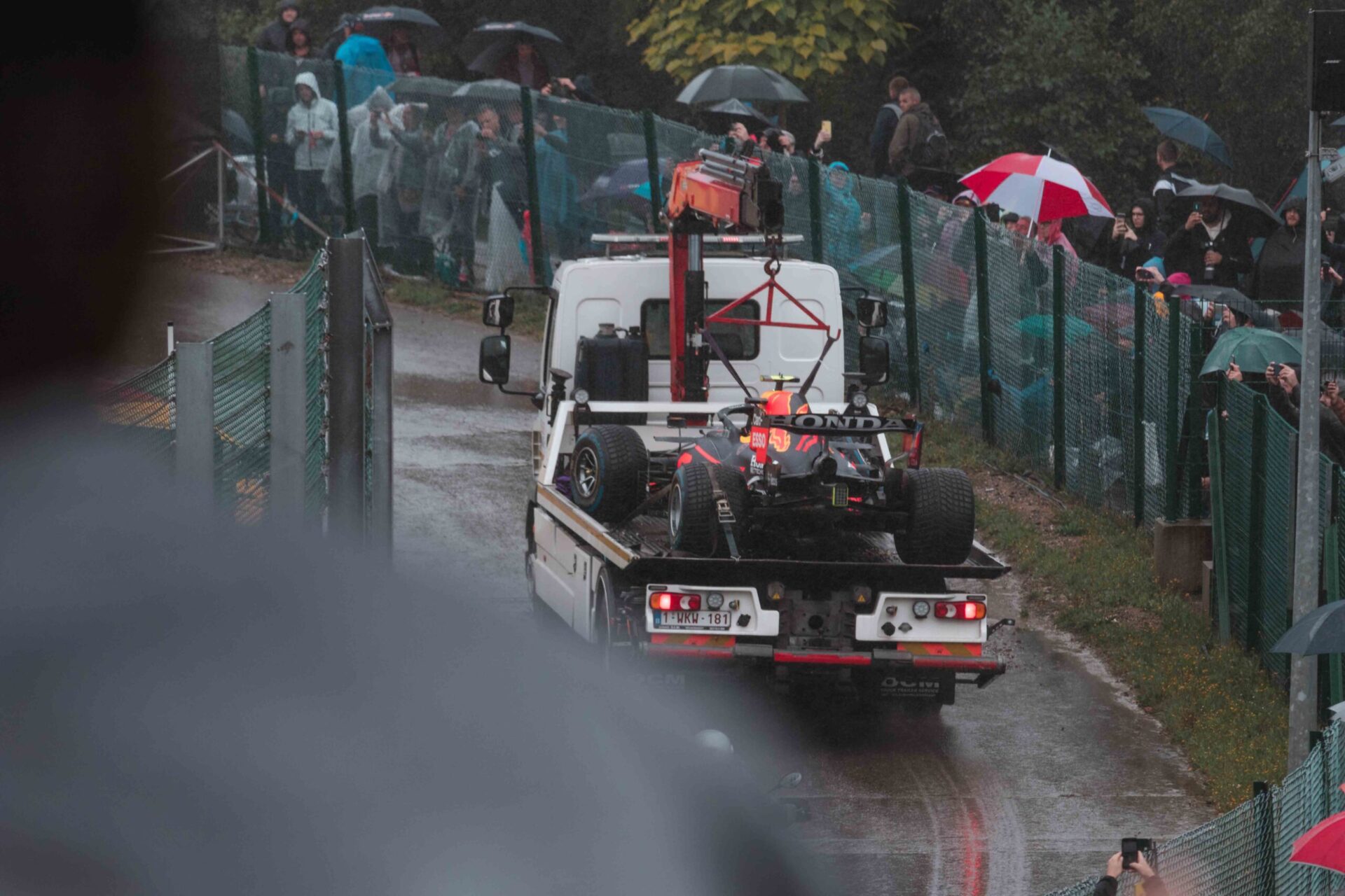 Broken F1 racing car of Sergio Perez on a transporter