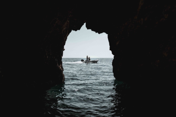 A boat seen out the blue cave in Zante Greece